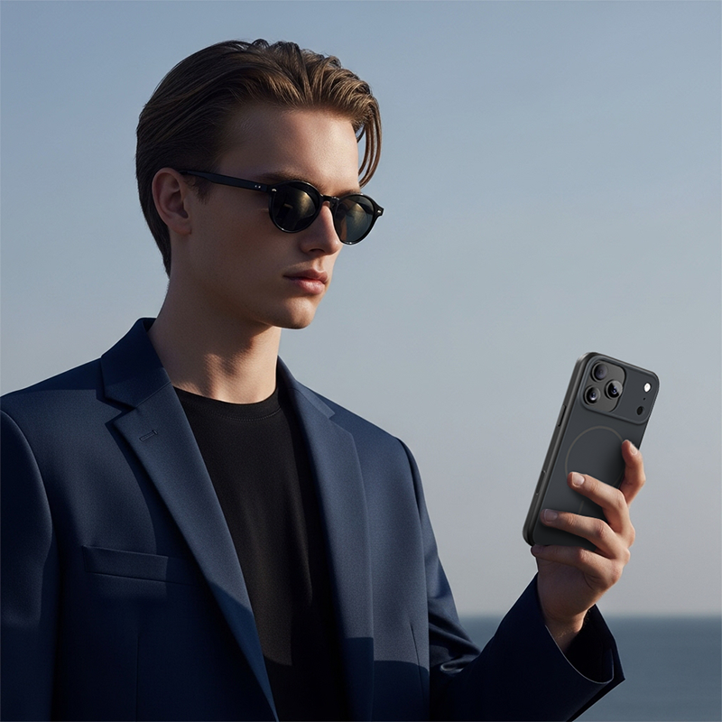 CASESUN-Businessman holding black iPhone 17 Pro Max matte magnetic case outdoors in lifestyle scene.